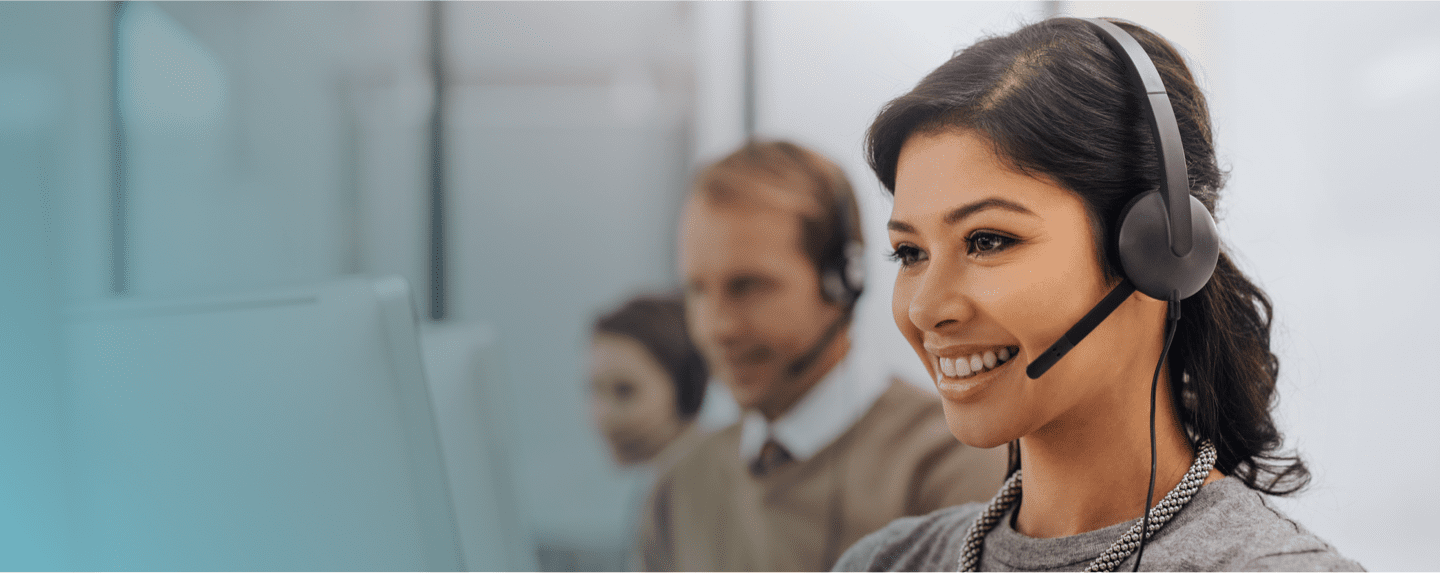 Photograph of a smiling provider service representative on a phone call via her headset